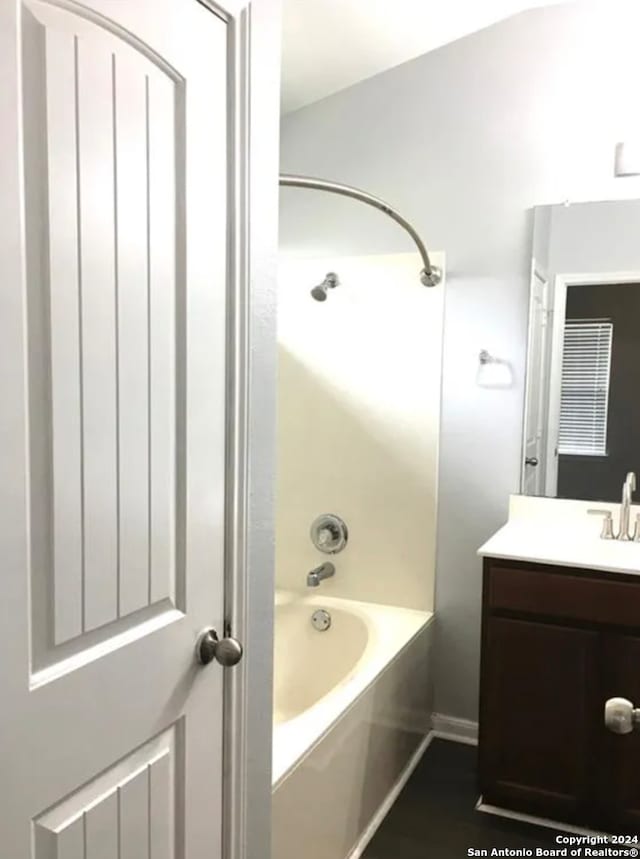 bathroom with vanity and a bathtub