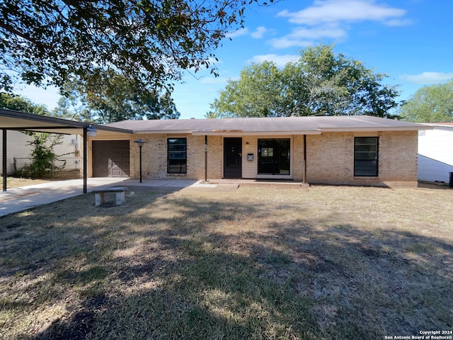 single story home with a garage and a front lawn