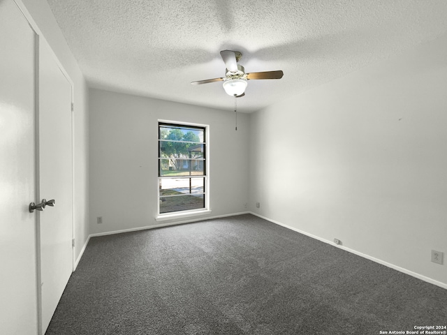 spare room with carpet flooring, a textured ceiling, and ceiling fan