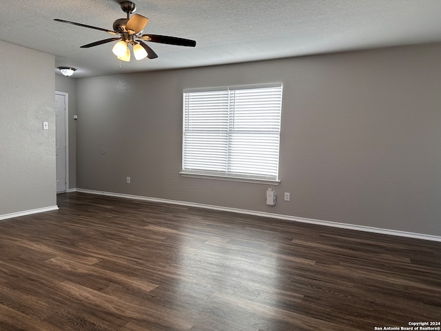 empty room featuring dark hardwood / wood-style floors, a textured ceiling, and ceiling fan