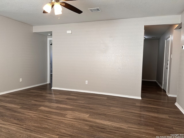 spare room featuring ceiling fan, a textured ceiling, and dark wood-type flooring