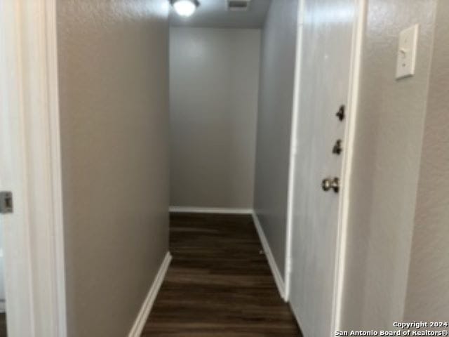 hallway with dark hardwood / wood-style floors