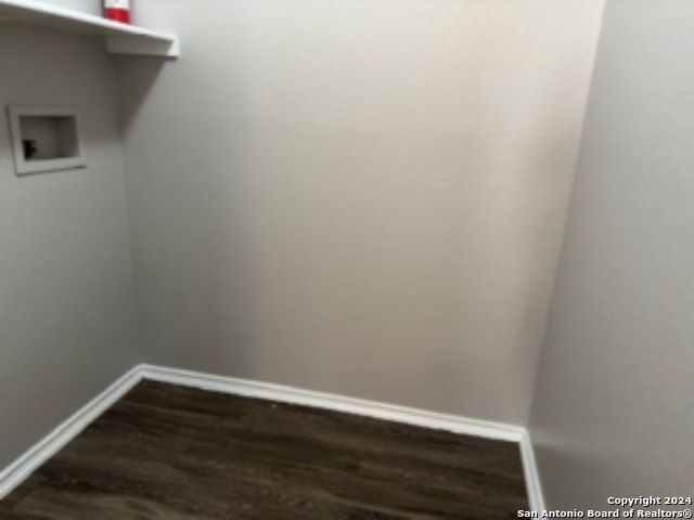 washroom featuring washer hookup and dark hardwood / wood-style flooring