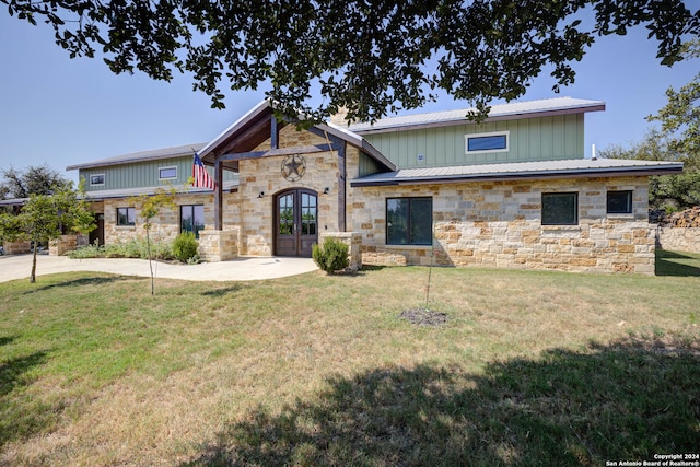 view of front of home featuring french doors and a front yard