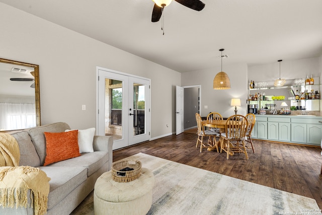 living room with french doors, dark hardwood / wood-style flooring, and ceiling fan