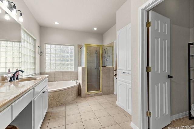 bathroom with shower with separate bathtub, tile patterned floors, and vanity