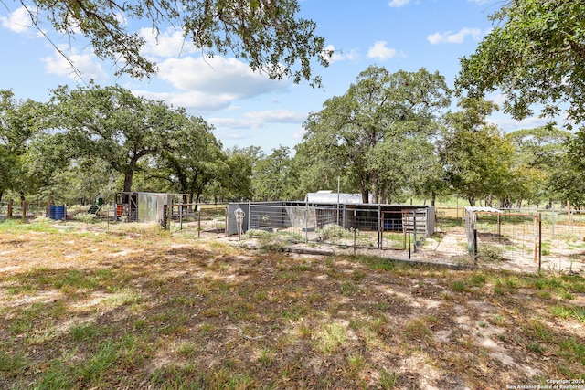 view of yard with a rural view and an outdoor structure