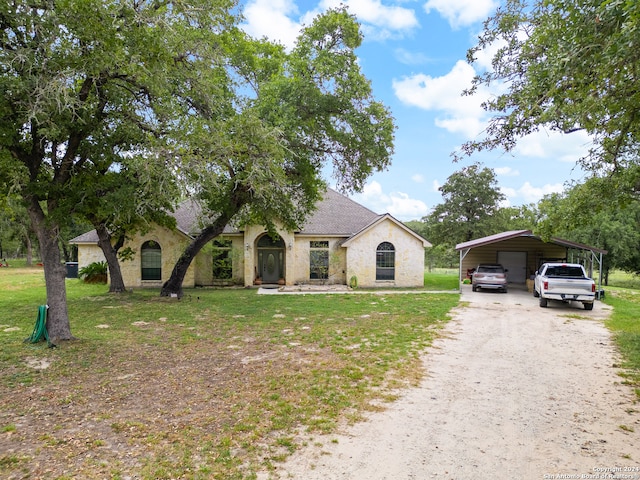 view of front of home with a front lawn and a carport