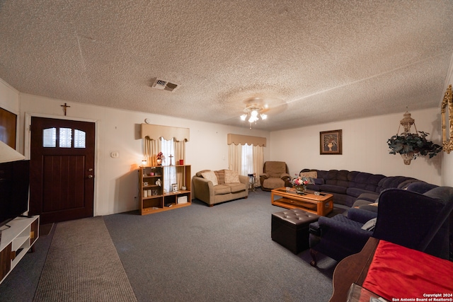 living room featuring carpet flooring, a textured ceiling, and ceiling fan