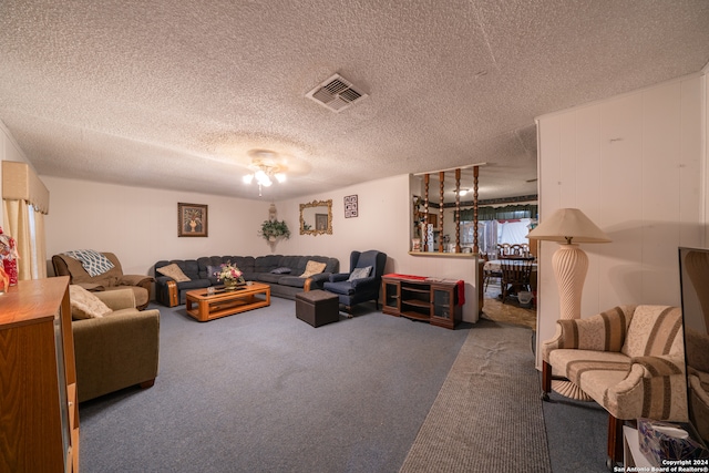 carpeted living room featuring a textured ceiling