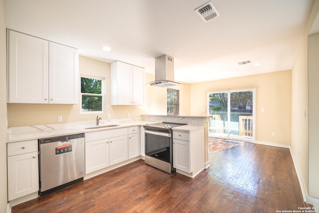114 S San Ignacio Ave, San Antonio, TX 78237 - kitchen featuring exhaust hood, appliances with stainless steel finishes, a sink, dark wood-style floors, and visible vents