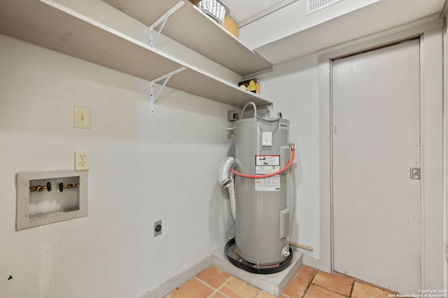 utility room featuring electric water heater and visible vents