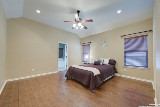 bedroom with wood-type flooring, connected bathroom, vaulted ceiling, and ceiling fan