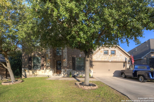 obstructed view of property with a garage and a front lawn