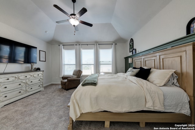 carpeted bedroom with ceiling fan and vaulted ceiling