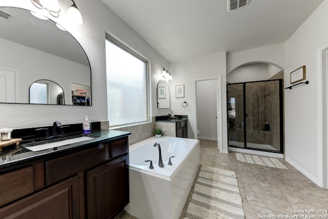 bathroom with vanity, independent shower and bath, and tile patterned flooring