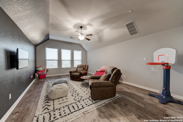 playroom featuring lofted ceiling, a textured ceiling, dark wood-type flooring, and ceiling fan