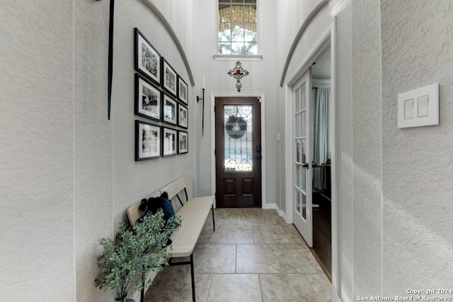 foyer entrance with french doors and a high ceiling