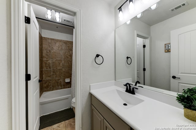 full bathroom featuring toilet, vanity, tile patterned floors, and shower / tub combo