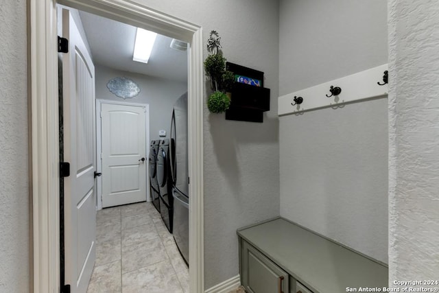 4815 Isaac Ryan, San Antonio, TX 78253 - mudroom featuring light tile patterned flooring, a textured wall, and washer and clothes dryer