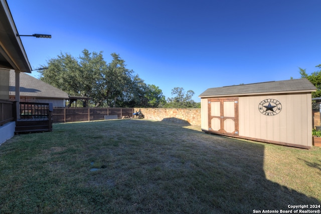 view of yard with a shed and a wooden deck