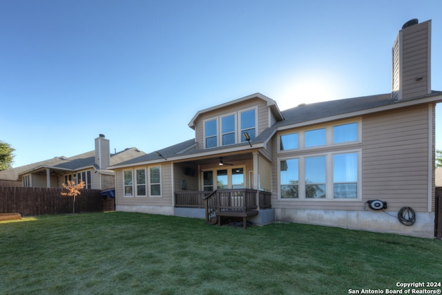 rear view of property featuring a lawn