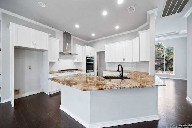 kitchen with wall chimney exhaust hood, kitchen peninsula, sink, and dark hardwood / wood-style flooring