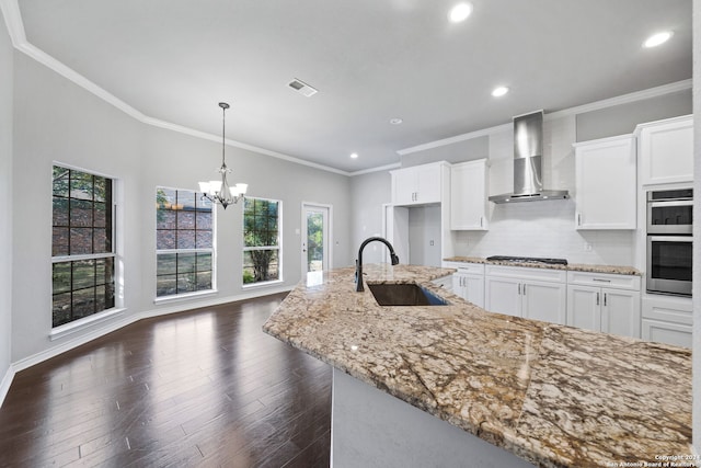 kitchen featuring wall chimney exhaust hood, dark wood-type flooring, and white cabinets