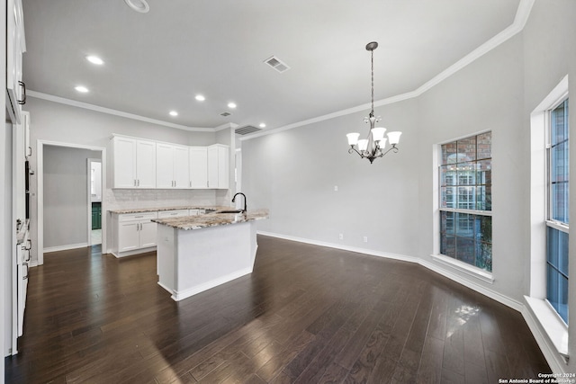 kitchen featuring pendant lighting, light stone countertops, dark hardwood / wood-style flooring, and white cabinetry