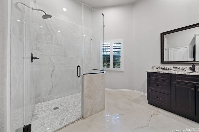 bathroom with vanity and a shower with shower door