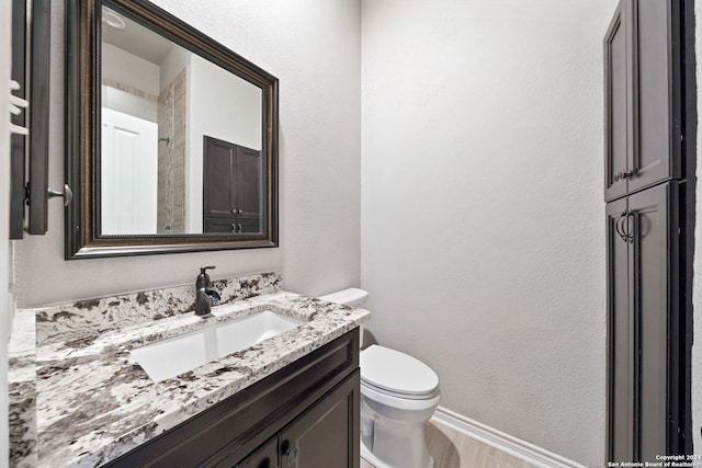 bathroom with vanity, hardwood / wood-style floors, and toilet