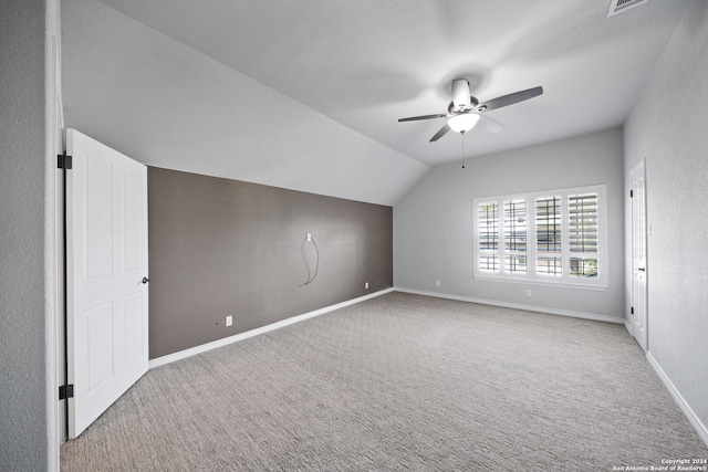 additional living space with carpet floors, lofted ceiling, and ceiling fan