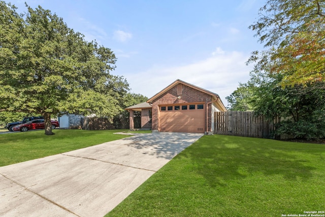 view of front facade with a garage and a front lawn