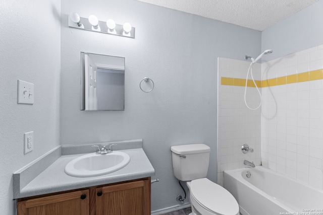 full bathroom with vanity, tiled shower / bath combo, toilet, and a textured ceiling