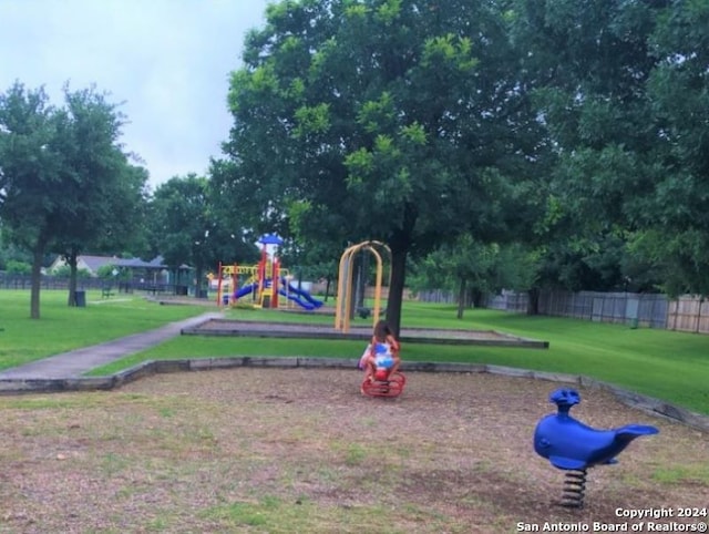 view of community featuring a playground and a yard