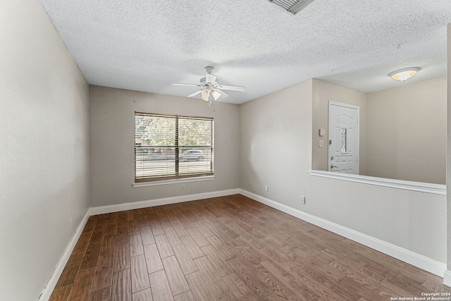 unfurnished room with hardwood / wood-style flooring, ceiling fan, and a textured ceiling