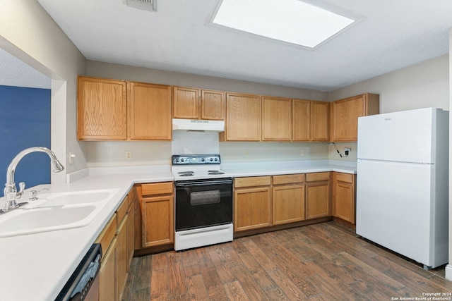 kitchen featuring white appliances, dark hardwood / wood-style floors, and sink