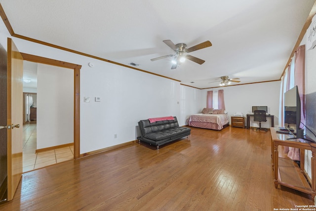 bedroom with ornamental molding and light hardwood / wood-style flooring