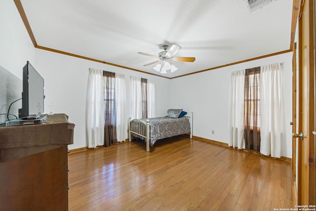 bedroom featuring ceiling fan, a textured ceiling, and hardwood / wood-style floors