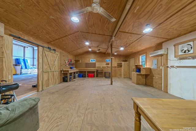 basement featuring wood ceiling, a wall mounted AC, a barn door, and ceiling fan