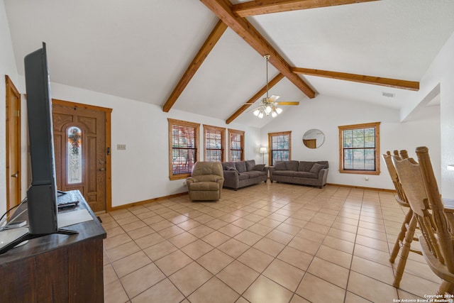 living room featuring ceiling fan, lofted ceiling with beams, light tile patterned floors, and a healthy amount of sunlight