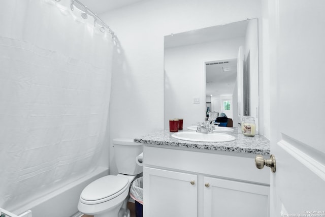 full bathroom with shower / tub combo, vanity, and toilet