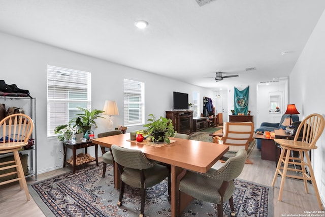 dining space featuring ceiling fan and light wood-type flooring