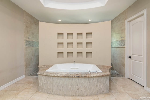 bathroom featuring independent shower and bath, tile walls, a raised ceiling, and tile patterned flooring