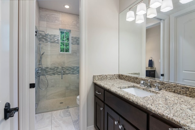 bathroom with an enclosed shower, toilet, vanity, and an inviting chandelier