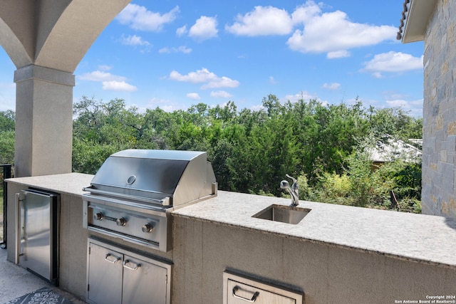 view of patio featuring area for grilling, sink, and a grill