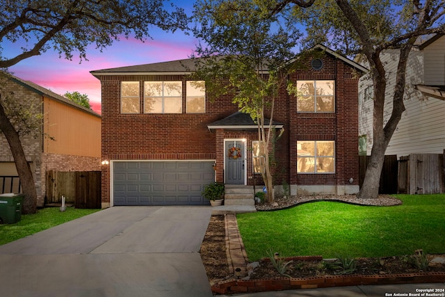 front of property with a yard and a garage