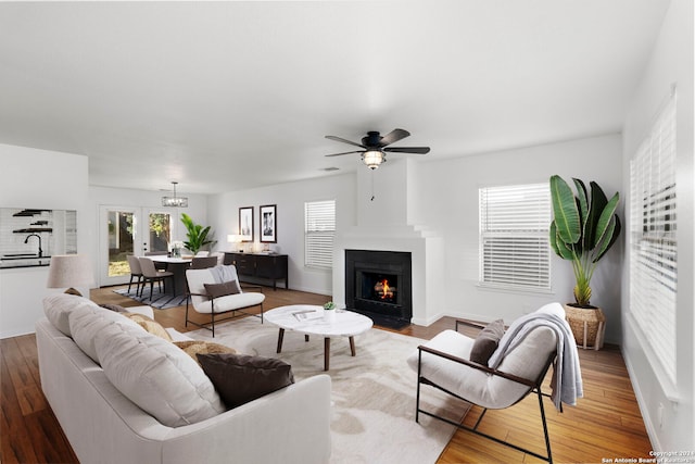 living room featuring hardwood / wood-style floors, ceiling fan, and a wealth of natural light