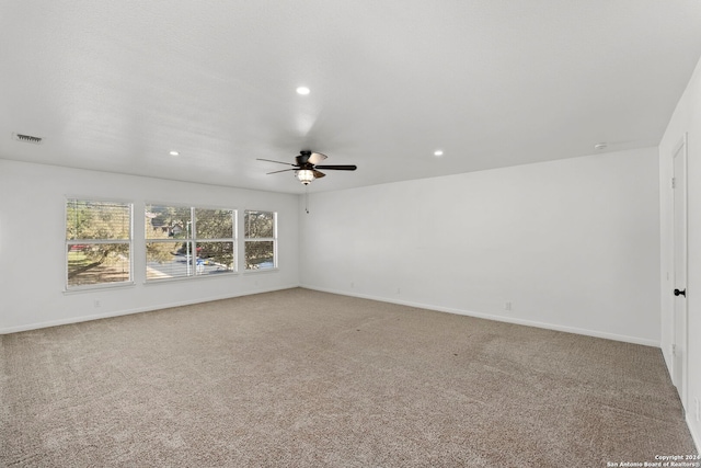 unfurnished room with carpet and ceiling fan