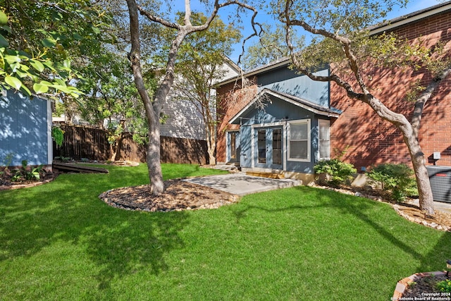 view of yard with a patio and french doors